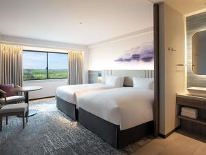Una cama o camas en una habitación de Grand Mercure Nasu Highlands Resort & Spa