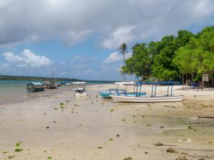 a group of boats sitting on the beach at Signature Collections by Eight Continents in Utende