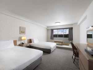 Postel nebo postele na pokoji v ubytování Mercure Fukuoka Munakata Resort & Spa