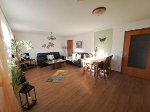 a living room with a couch and a table at Ferienwohnungen Blum in Kelberg