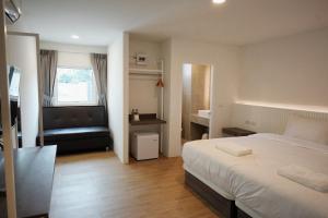 a hotel room with a bed and a couch at Matini Hotel BU 