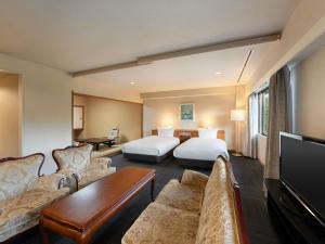 a hotel room with a bed and a couch at Mercure Urabandai Resort & Spa in Kitashiobara +78 photos