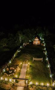 a house on a hill at night with lights at Vikendica GORSKI VUK Jelovica in Berane