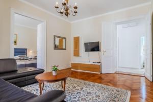 a living room with a couch and a table at Apartments & Rooms Flowers in Zagreb