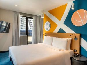 a bedroom with a bed and a basketball wall at ibis Styles Batumi Hotel in Batumi +62 photos