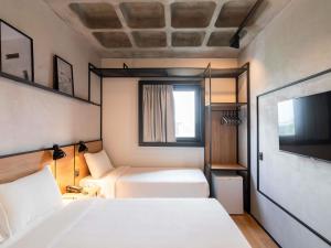 Postel nebo postele na pokoji v ubytování ibis Tubarão