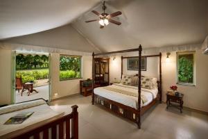 a bedroom with two beds and a ceiling fan at Varawal Leopard Camp in Mori Bera
