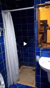 a bathroom with a shower curtain and a sink at Escape to Heaven in Sharm El Sheikh