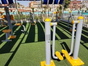 a playground with yellow and white equipment on the grass at Escape to Heaven in Sharm El Sheikh +1 photo