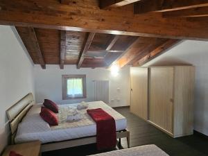 a bedroom with a bed and a wooden ceiling at MUM & DAD - Loft in Sale Marasino