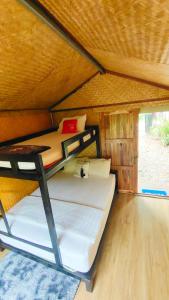 ein Schlafzimmer mit zwei Etagenbetten in einer Kabine in der Unterkunft โฮมสเตย์ เนเจอร์ เดอ สะปัน Nature De Sapan in Ban Huai Ti
