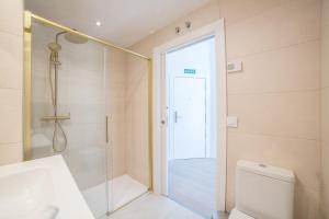 a bathroom with a shower and a sink and a toilet at Las villas de Manuel in Salamanca +19 photos