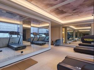 a gym with treadmills and mirrors in a room at Mercure Hangzhou West Lake Fengqi Road in Hangzhou
