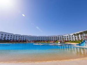 a large building with a swimming pool in front of it at Rixos Radamis Sharm El Sheikh in Sharm El Sheikh