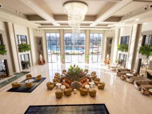 a large lobby with couches and a chandelier at Rixos Radamis Sharm El Sheikh in Sharm El Sheikh +95 photos