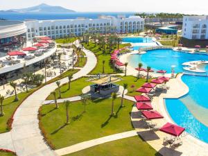 an aerial view of a resort pool with red umbrellas at Rixos Radamis Sharm El Sheikh in Sharm El Sheikh +98 photos