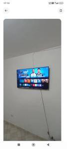 a flat screen tv hanging on a white wall at Refúgio em São Paulo in Sao Paulo