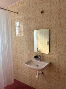 a bathroom with a sink and a mirror on the wall at Casa de Aaron in Colva +23 photos
