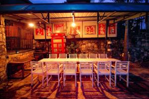 a white table and chairs in a room at Skyhill Kandy in Hindagala