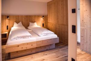 En eller flere senge i et værelse på Noe Dolomite Residence