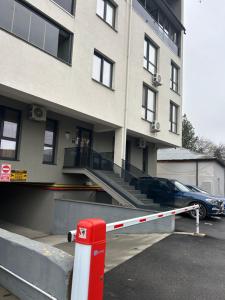 a building with a parking lot with a ramp to a car at C&E Apart in Craiova
