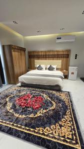 a bedroom with a large bed with a large rug at شقق المطار in Jeddah +9 photos