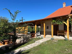 a house with a pavilion with a couch in the yard at Panoráma Terasz Vendégház in Noszvaj