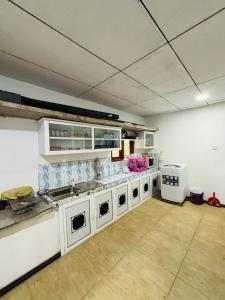 Una gran cocina con electrodomésticos blancos en una habitación. en Uvindu Villa - Cozy By Midigama, en Weligama