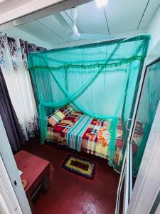 a bedroom with a bed with a canopy at Uvindu Villa - Cozy By Midigama in Weligama +37 photos