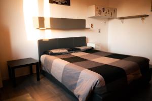 een slaapkamer met een bed met een zwart-witte deken bij Casa Tricy B&B in Bologna
