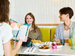 a group of people sitting around a table eating food at TRIBE Paris Clichy in Clichy