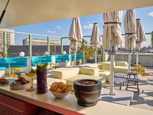a patio with tables and chairs and umbrellas at TRIBE Paris Clichy in Clichy