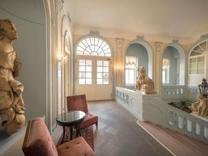 a living room with a statue and a table at The Mozart Prague in Prague