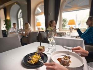 a person sitting at a table with a plate of food at The Mozart Prague in Prague