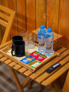 a wooden table with water bottles and glasses on it at City View Residence in Islamabad