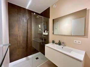 une salle de bain avec un lavabo, une douche et un miroir dans l'établissement Appartement moderne 2 chambres & 2 parking à Koksijde by La Conciergerie, à Coxyde 12 autres photos