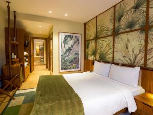 a bedroom with a large white bed with a green rug at ibis Styles Istanbul Kurtkoy in Istanbul +62 photos