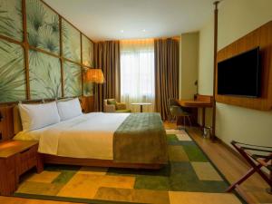 a hotel room with a bed and a flat screen tv at ibis Styles Istanbul Kurtkoy in Istanbul