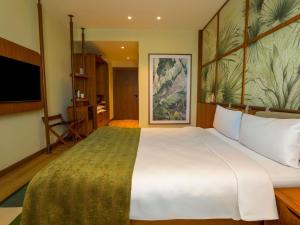 a large white bed in a room with a tv at ibis Styles Istanbul Kurtkoy in Istanbul