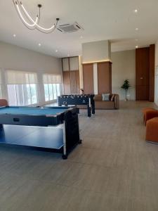 a large room with couches and a pool table at AL Homestay with 3 Bedrooms in Alor Setar +12 photos
