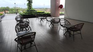 a group of chairs and tables on a patio at AL Homestay with 3 Bedrooms in Alor Setar