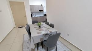 a dining room with a table and some chairs at AL Homestay with 3 Bedrooms in Alor Setar