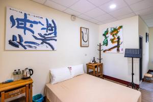 Postel nebo postele na pokoji v ubytování 台灣意象書法館