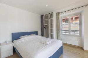 a bedroom with a large bed and a window at Au coeur des Alpes 4 in La Roche-sur-Foron +5 photos