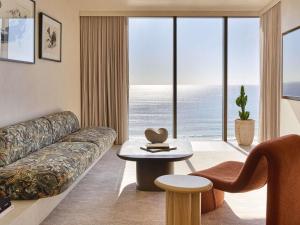 a living room with a couch and a table at Mondrian Gold Coast in Gold Coast