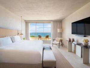 a hotel room with a large bed and a large window at Fairmont La Hacienda Costa del Sol in Alcaidesa +174 photos