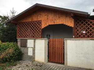 a small wooden building with a large door at Apartment Šárka in Strupčice