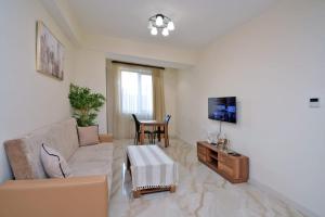 a living room with a couch and a table at Lavelo Apartments in Yerevan
