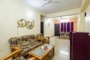 a living room with a couch and a table at Pretty Garden View Apartment 3BHK Furnished Flat near Kashi Vishwanath Temple in Varanasi