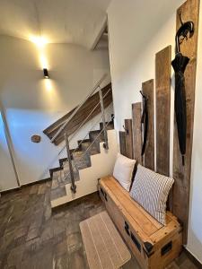 a living room with a wooden bench and stairs at Seeidyll an der Wublitz in Werder
